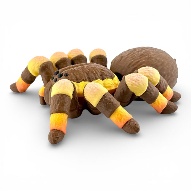 Tarantula figurine side profile showing orange gradient legs