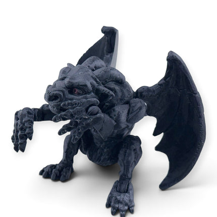 Gargoyle figurine close-up of clawed hands and snarling expression