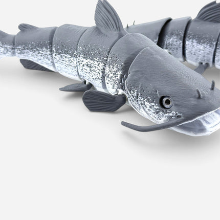 Tidal 3D Printed articulated catfish toy in grey PLA+ filament with realistic glass eyes and textured details